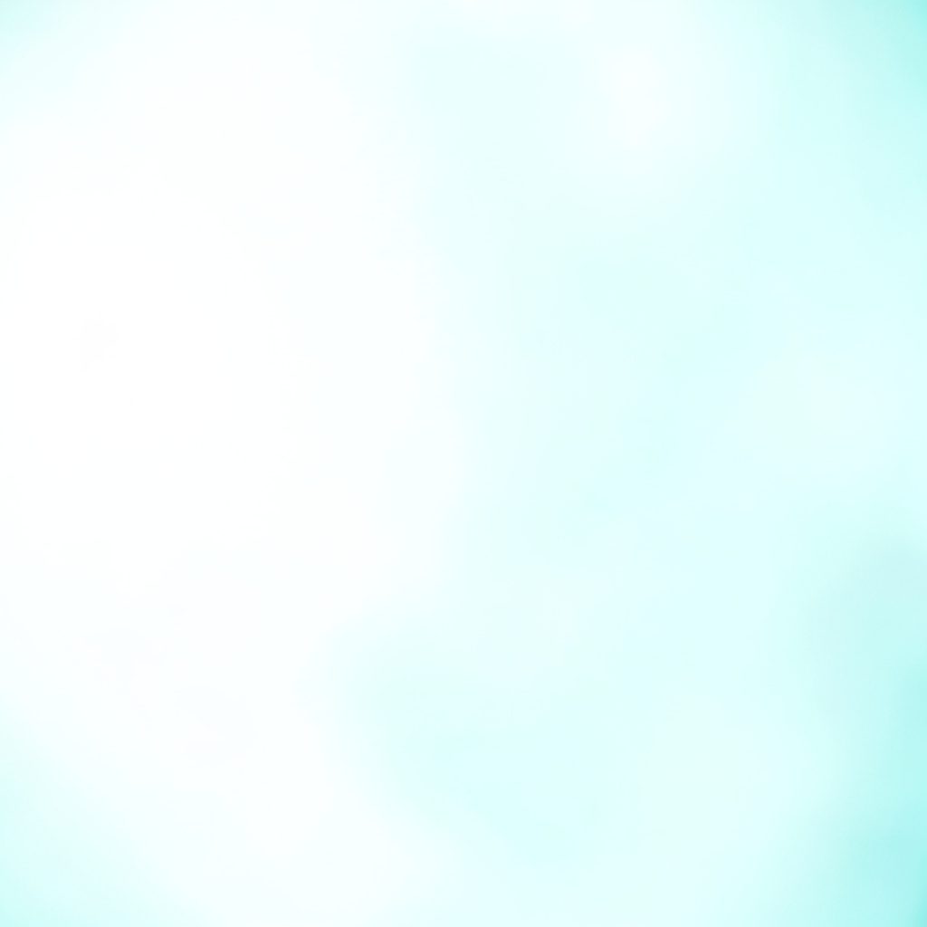 Medication strip and small box on a bright white tabletop with soft teal-tinted shadows